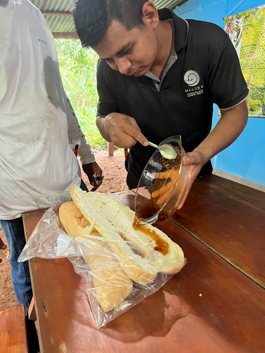 Gilbert, cacao specialist at Blue Valley Chocolate, sharing his knowledge during a farm tour